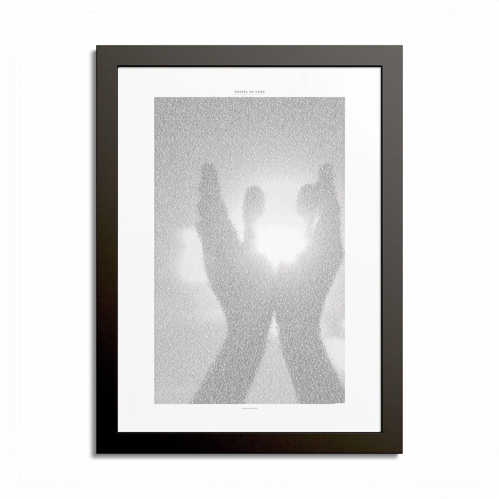 Framed print of the Gospel of Luke, shaped into hands raised toward the light